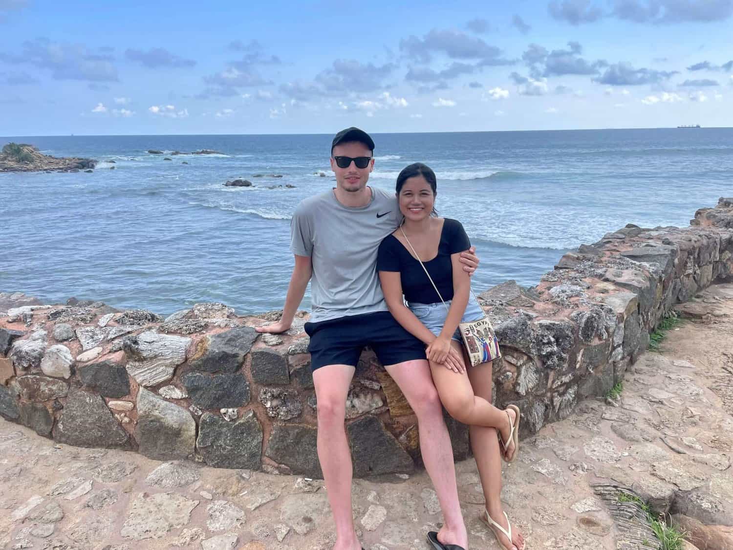 Me and my partner sitting on a rock in Sri Lanka.