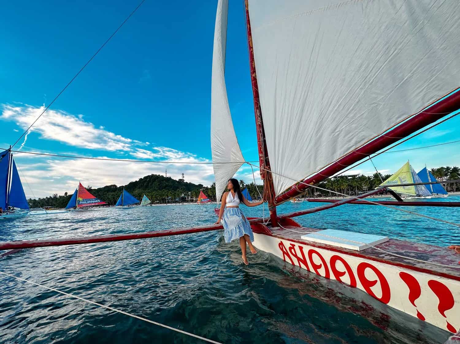 I am siting on a paraw sailboat during paraw sailing, one of the water activities in Boracay.