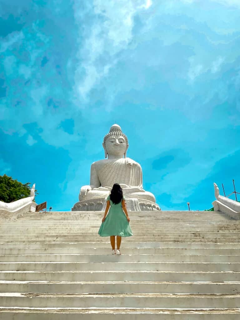 A photo of me wearing below the knee dress showing the appropriate dress code for Big Buddha Phuket. I am also looking to the Big Buddha Phuket as a sign of respect and I'm walking on the 94 steps to the Big Buddha Phuket.
