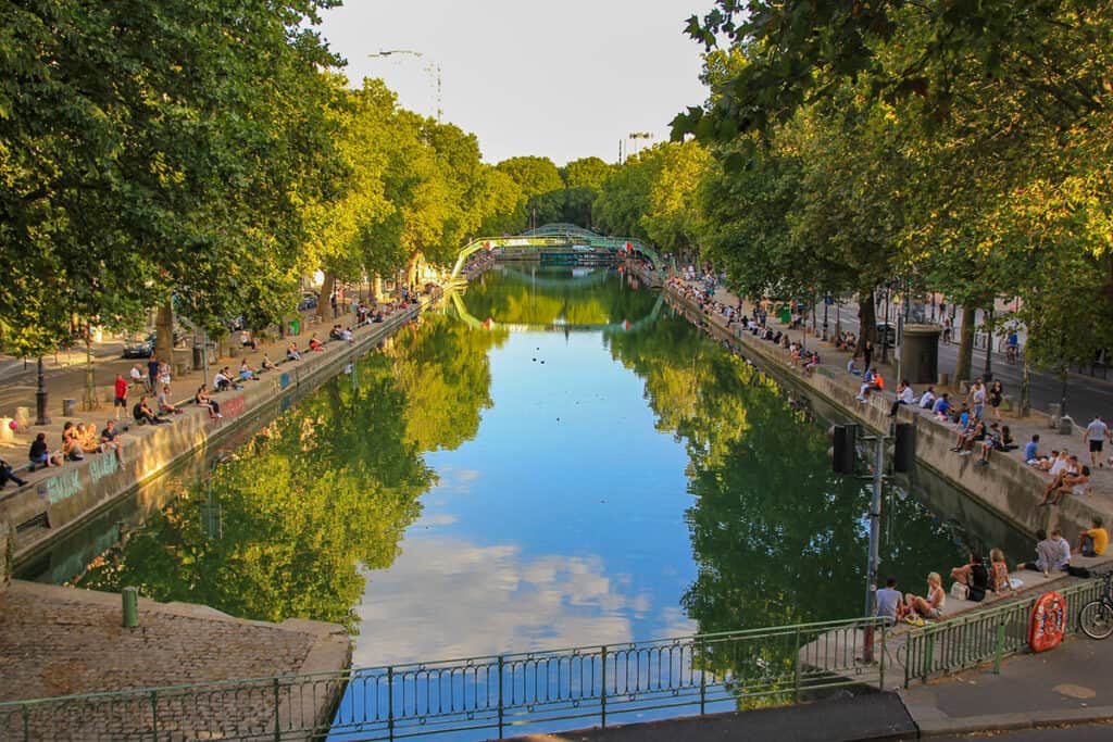 Scenic view of Canal Saint Martin with lined trees in Paris.
