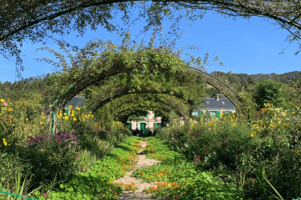 Picturesque garden at Giverny, showcasing blooming flowers and tranquil ponds.