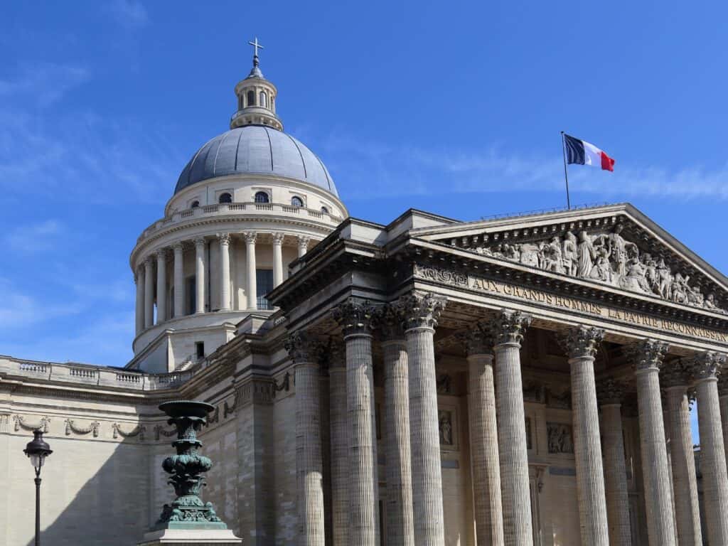 Interior of the Panthéon in Paris with classical columns and a dome.