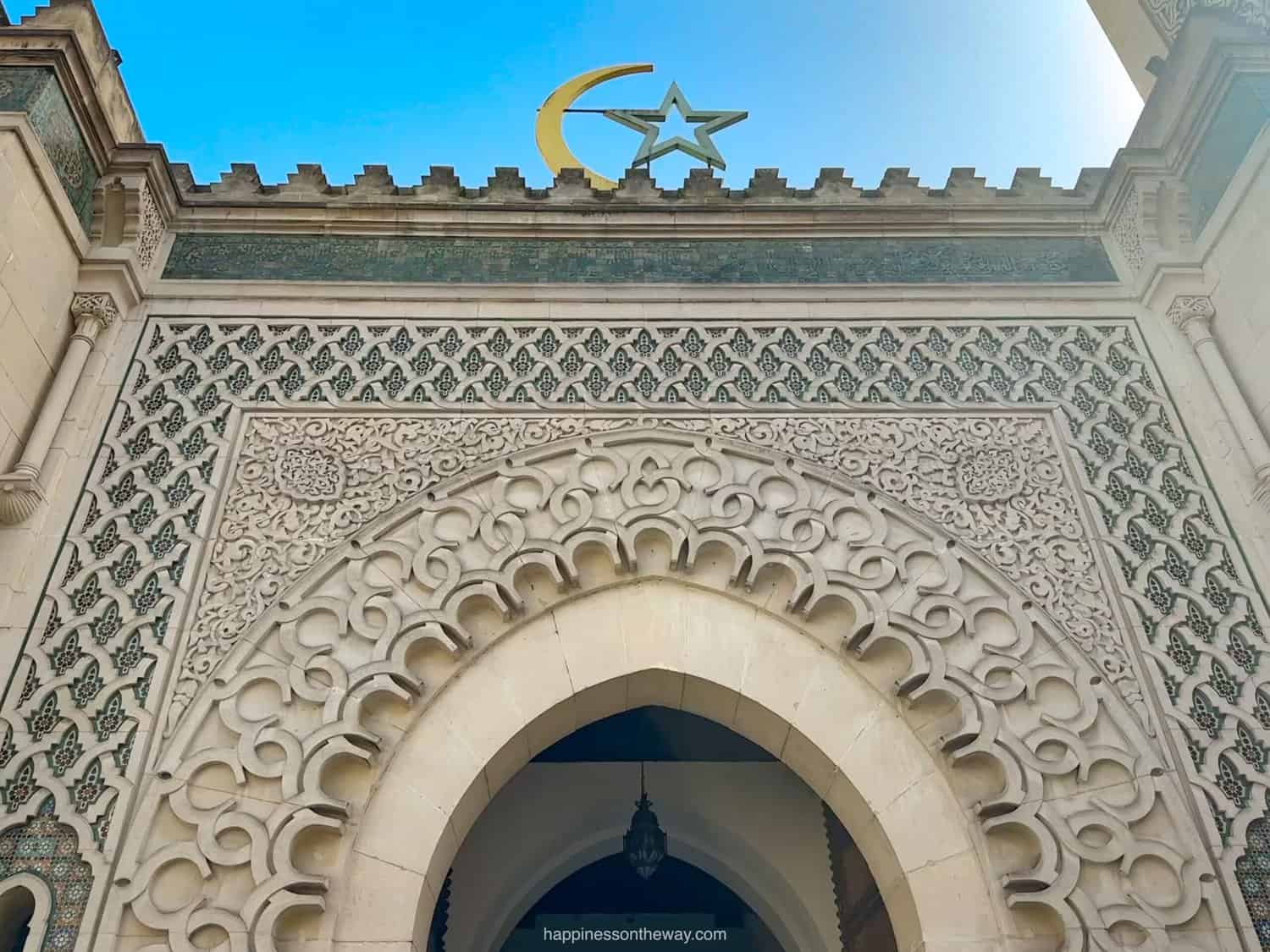 Intricately designed entryway of the La Grande Mosque, featuring elegant arches and tilework.