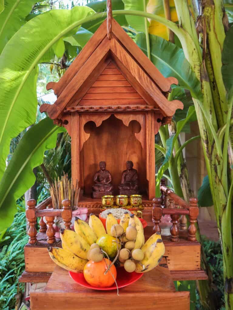 Elaborate traditional offerings for Cambodian New Year 2024, including fruits, flowers, and incense, set against a spiritual backdrop to honor ancestors and deities.