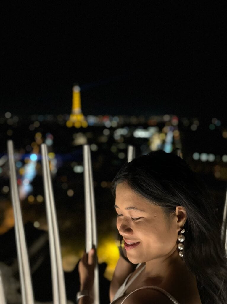Yours truly happily seeing the Eiffel Tower Light Show at Arc de Triomphe