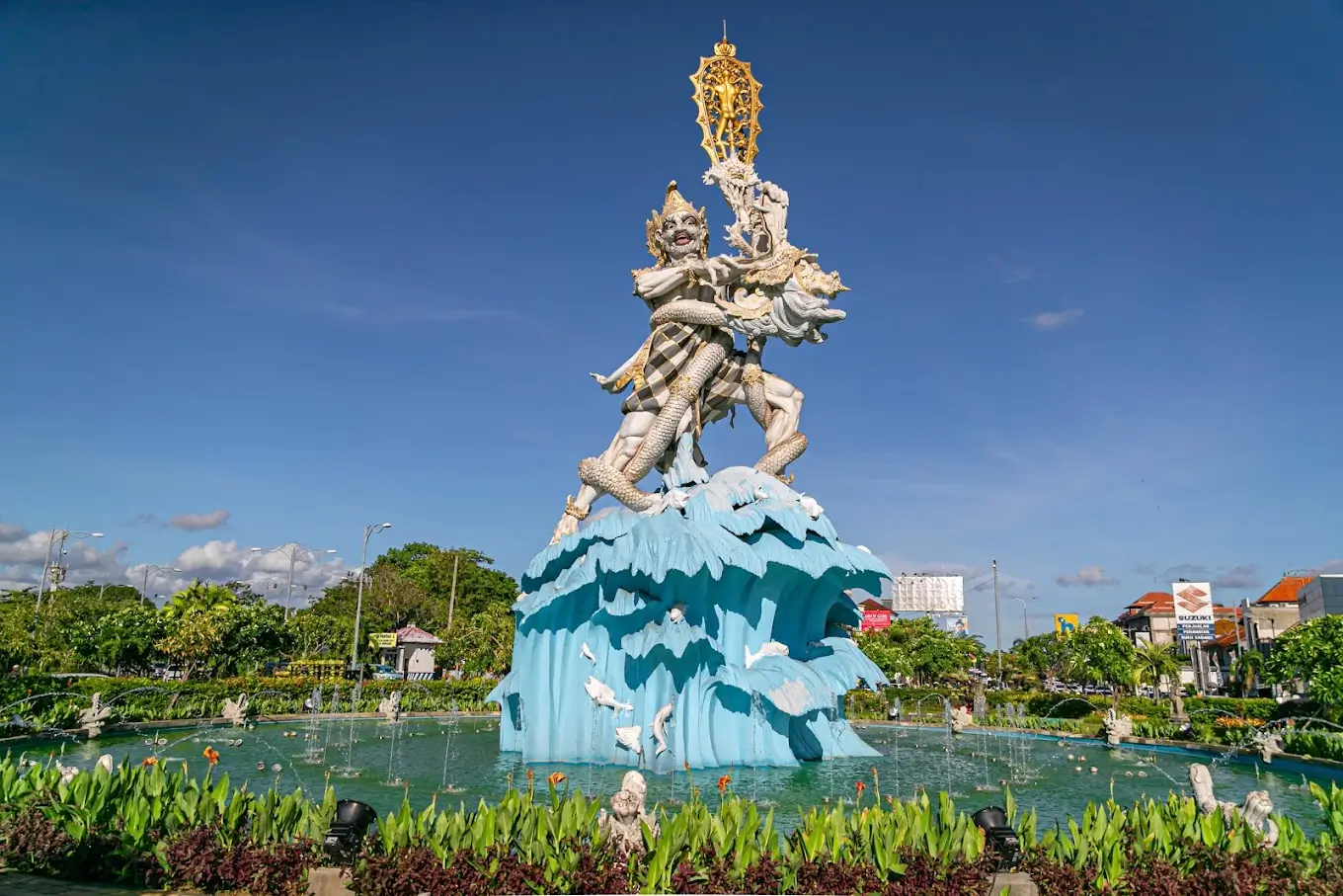 The Dewa Ruci Statue in Bali, Indonesia, depicting a striking scene of a deity standing atop swirling blue waves. 