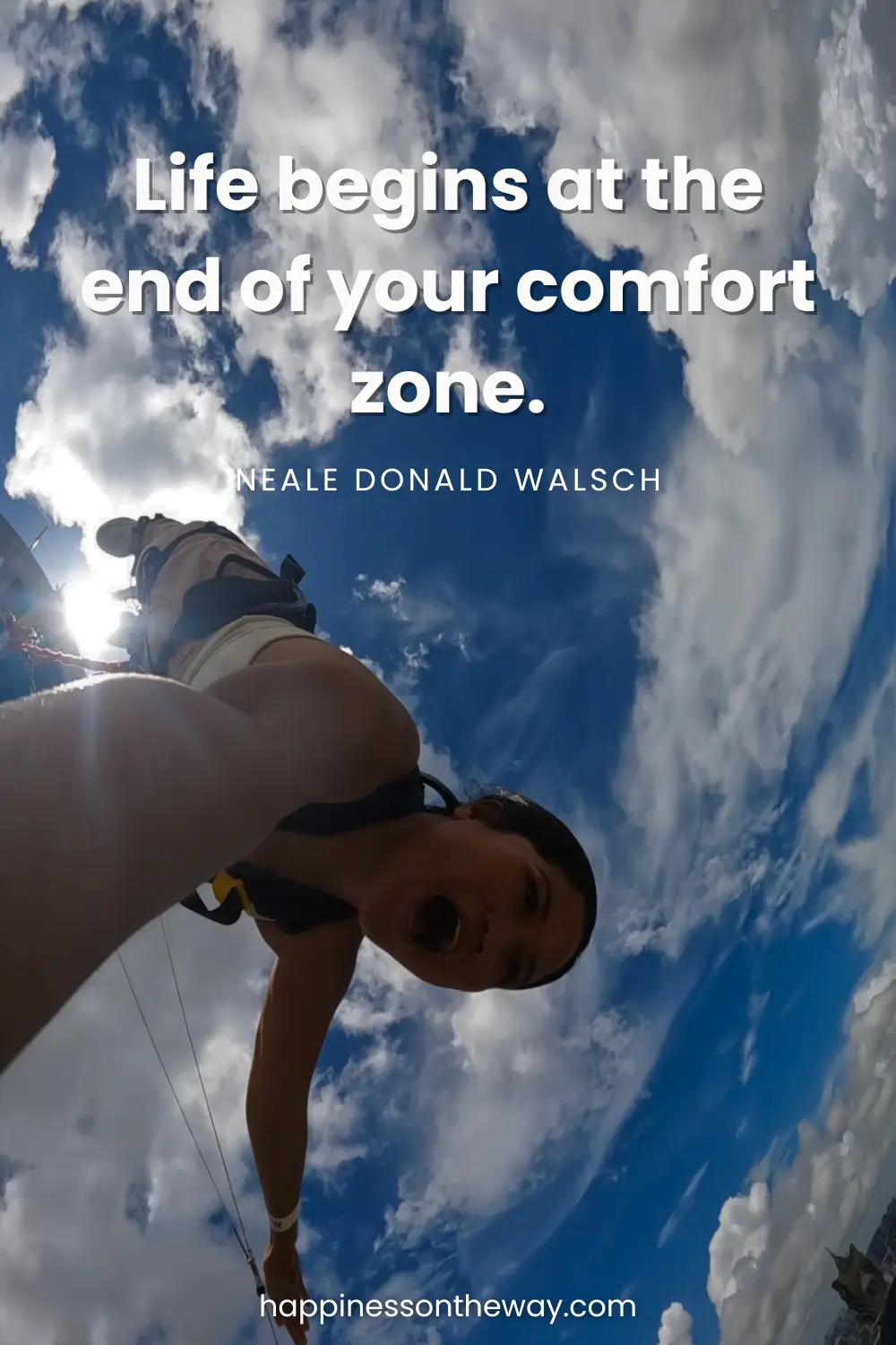 An exhilarating point-of-view shot of me bungee jumping in action, diving into the sky with clouds surrounding, embodying the slow travel quote 'Life begins at the end of your comfort zone' by Neale Donald Walsch.