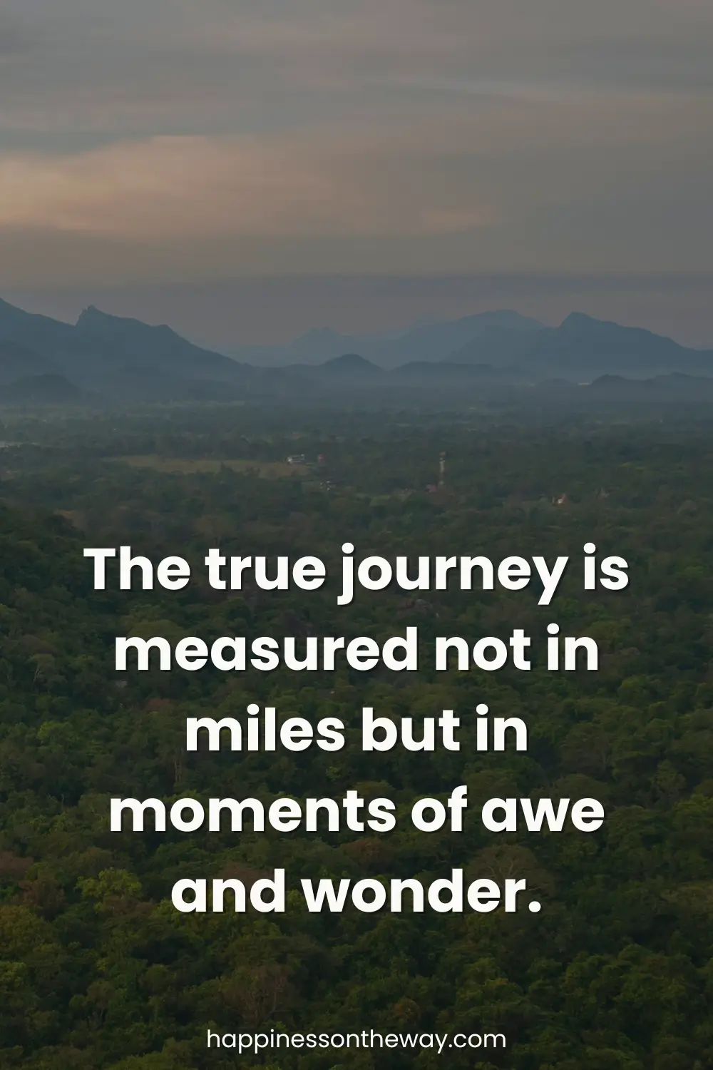 Scenic landscape of a valley with misty mountains under a dusk sky, paired with the quote 'The true journey is measured not in miles but in moments of awe and wonder.'