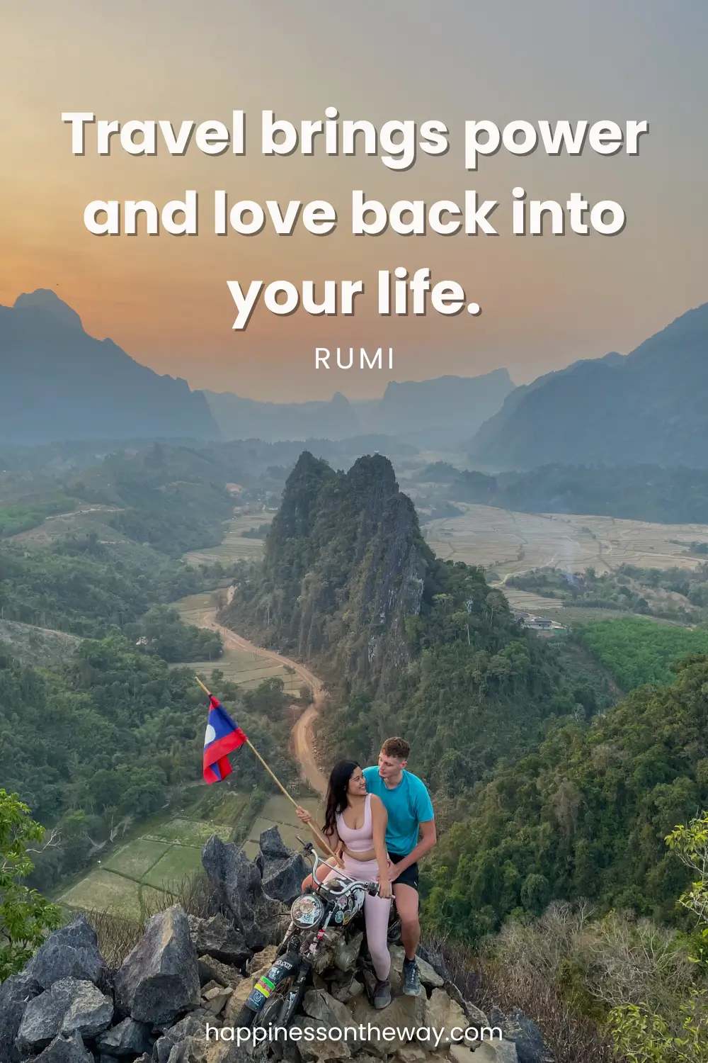 An intimate moment atop a mountain at dusk with me and my partner seated close to each other, holding a Laotian flag, overlooking a valley, encapsulating the essence of Rumi's slow travel quote 'Travel brings power and love back into your life.