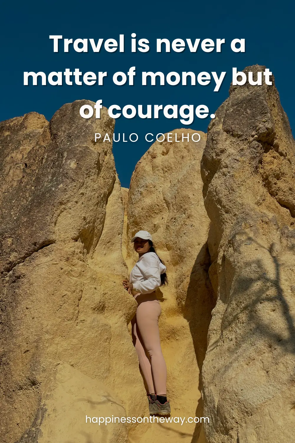 Me poised between rugged rock formations in Pai Canyon under a clear blue sky, accompanied by Paulo Coelho's quote 'Travel is never a matter of money but of courage.