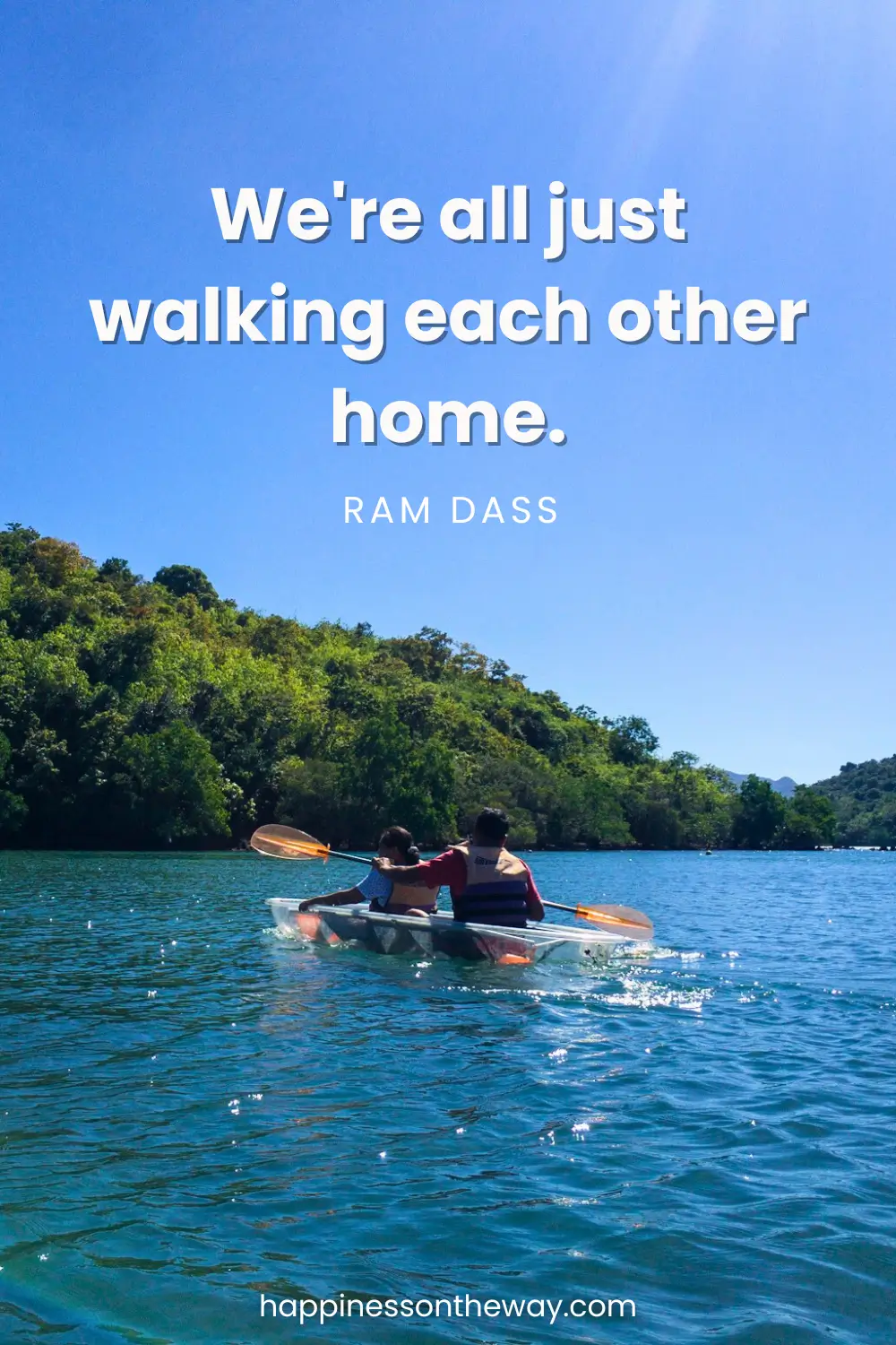 My parents kayaking in a tranquil blue lake surrounded by lush greenery under a clear sky, with the profound Ram Dass quote 'We're all just walking each other home.'