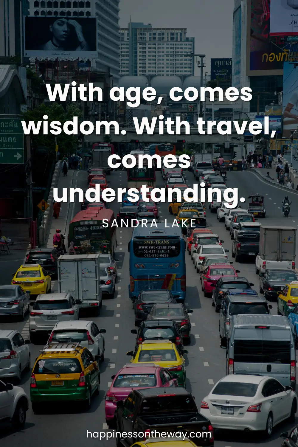 Busy city traffic with a variety of colorful cars on a multi-lane road, under a billboard and urban buildings, overlayed with the insightful slow travel quote 'With age, comes wisdom. With travel, comes understanding.' by Sandra Lake