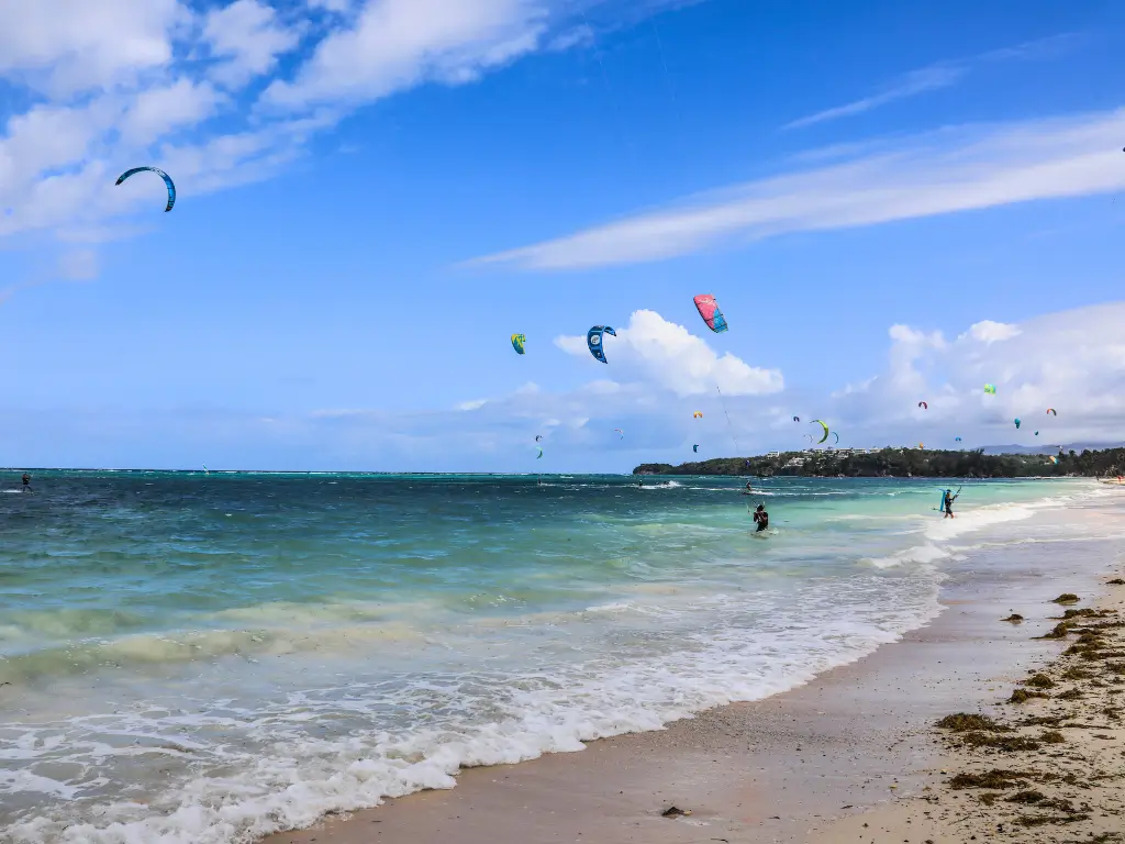 Kitesurfers glide over the waves at Bulabog Beach, a vibrant water sports hub and part of Boracay land tour destinations.