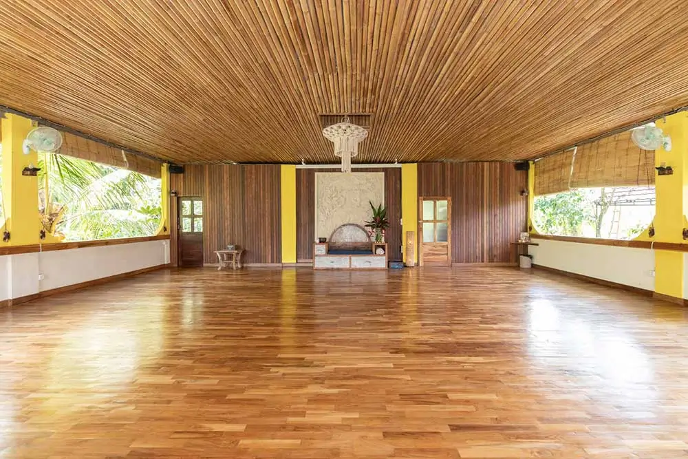 Spacious and serene yoga studio with natural light and tropical views at a silent meditation retreat in Bali