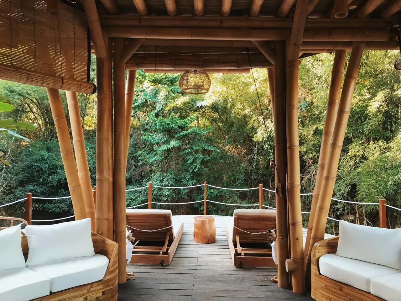 Bamboo relaxation deck with plush seating overlooking a tranquil forest at Sun Sang Eco Healing Retreats in Bali