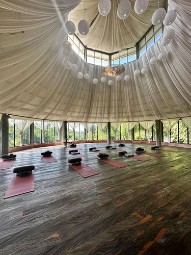 Meditation hall with circular ceiling and panoramic forest views at The Yogi’s Garden, offering a serene space for silent meditation retreats in Bali.