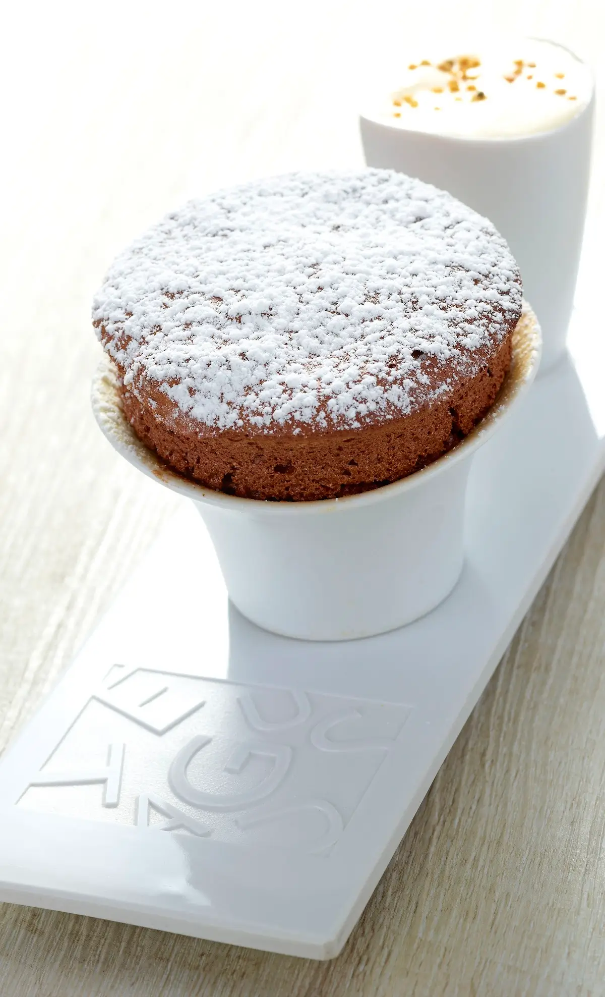 Chocolate soufflé dusted with powdered sugar at Auguste, a Michelin Star restaurant in Paris."