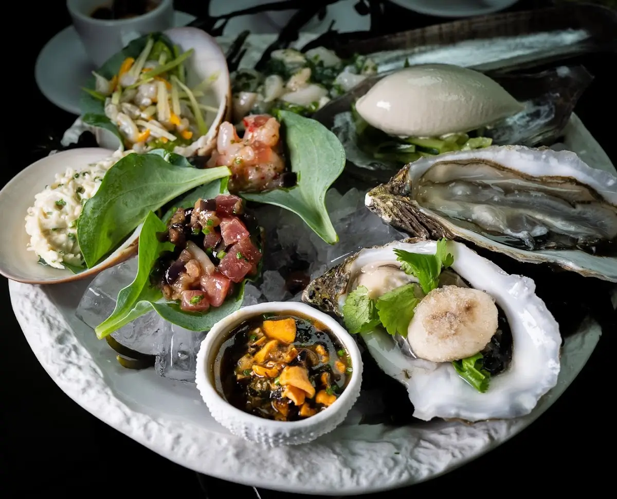 eafood platter with oysters and garnishes at Restaurant Gaya, an affordable Michelin Star restaurant in Paris.