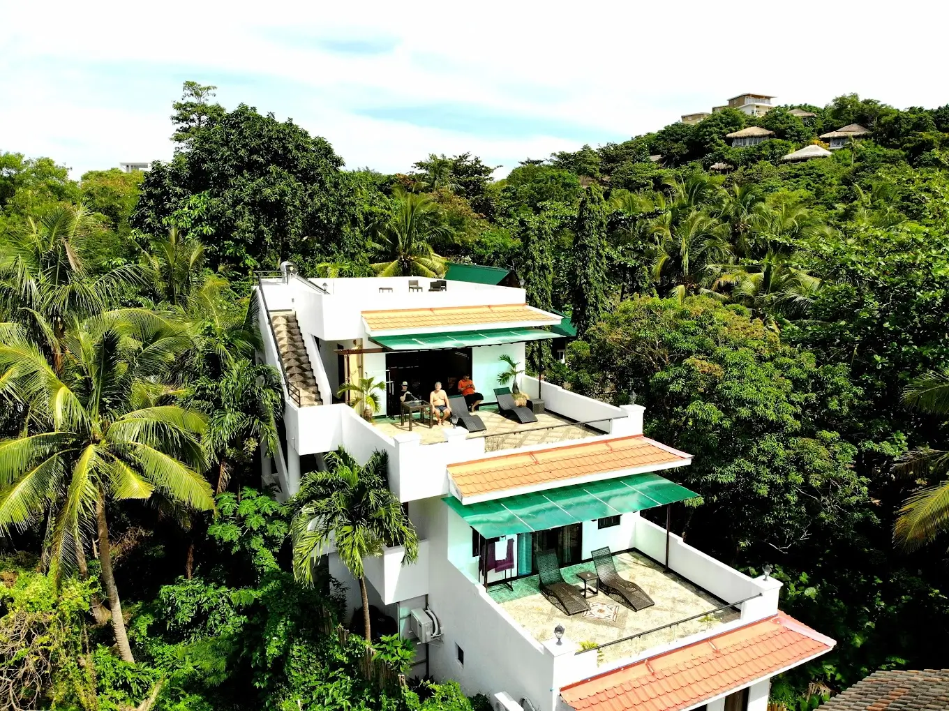 Aerial view of Sulu Sea Boutique Hotel, a boutique resort in Boracay, nestled among dense tropical foliage. The resort features multiple terraces and is surrounded by lush greenery, providing a secluded retreat.