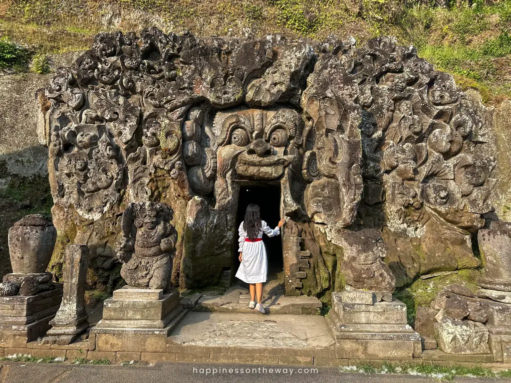 Me in my white dress entering Goa Gajach cave with intricate scuptures and a mouth of a monster entrance