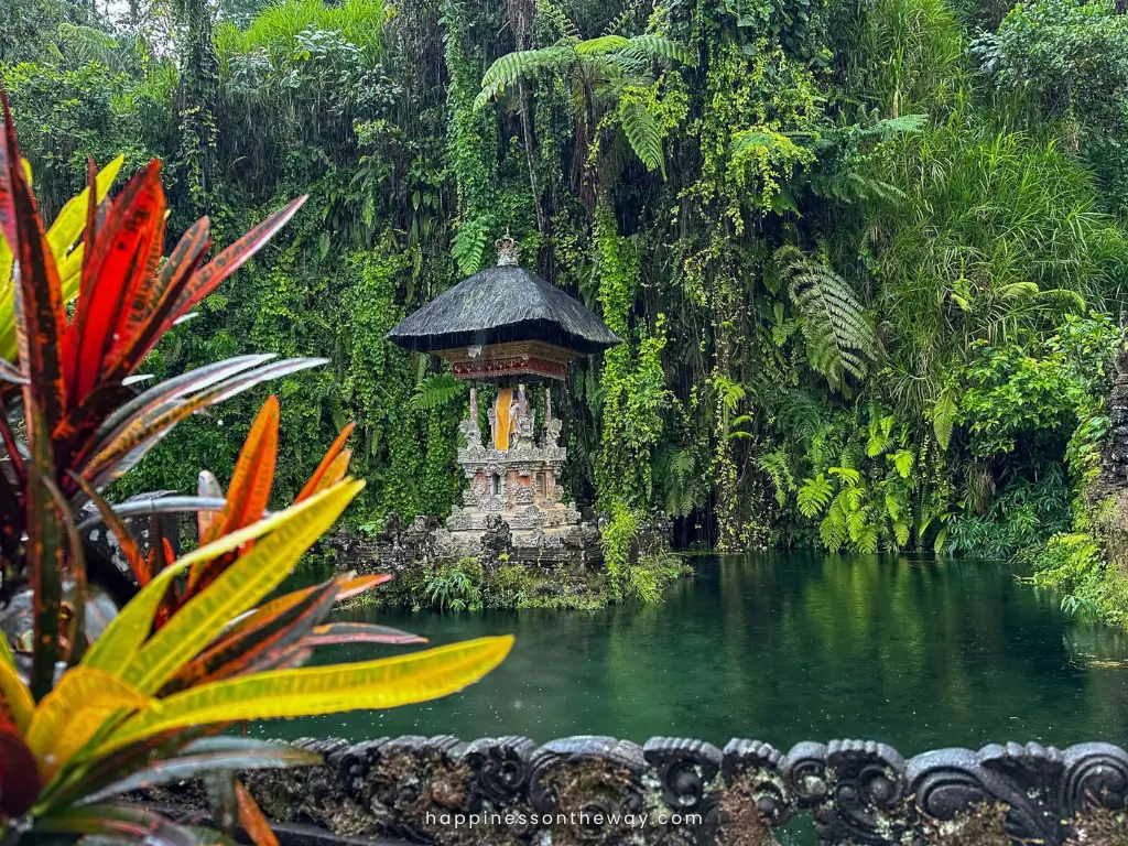 A Balinese shrine in a lake with plants on the background in Gunung Kawi Sebatu.