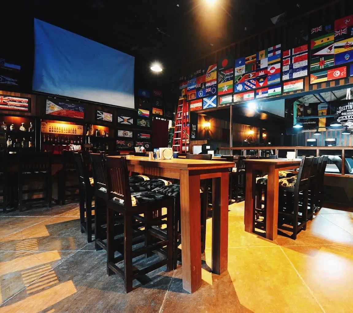 Chairs, tables, games with flags of different countries in Melting Pot Saloon