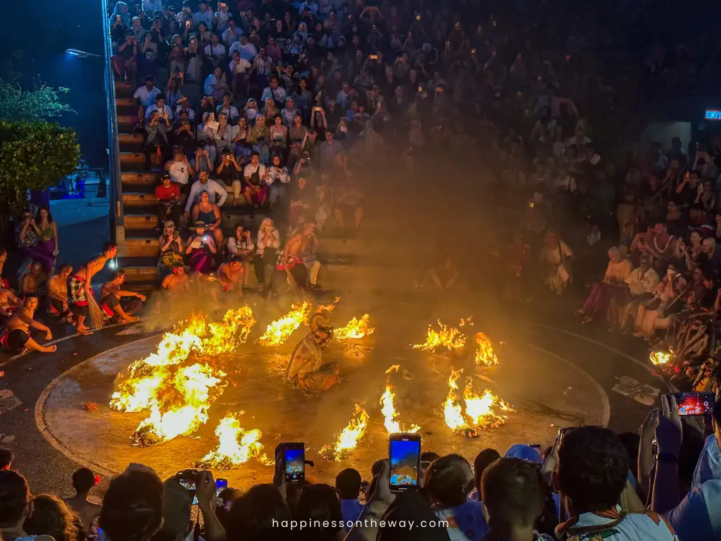  large crowd watching a dramatic Kecak and fire dance performance in Ubud at night, one of the best things to in Ubud at night.