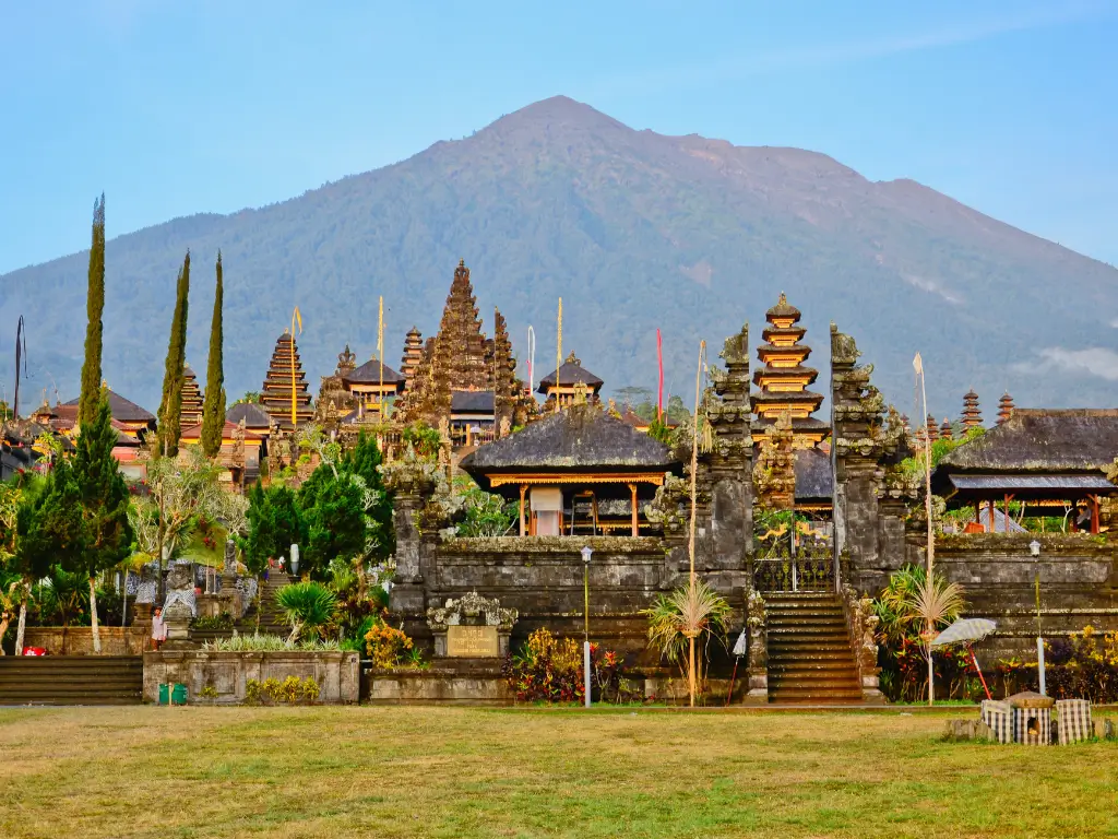 A temple compound with a big mountain on the background