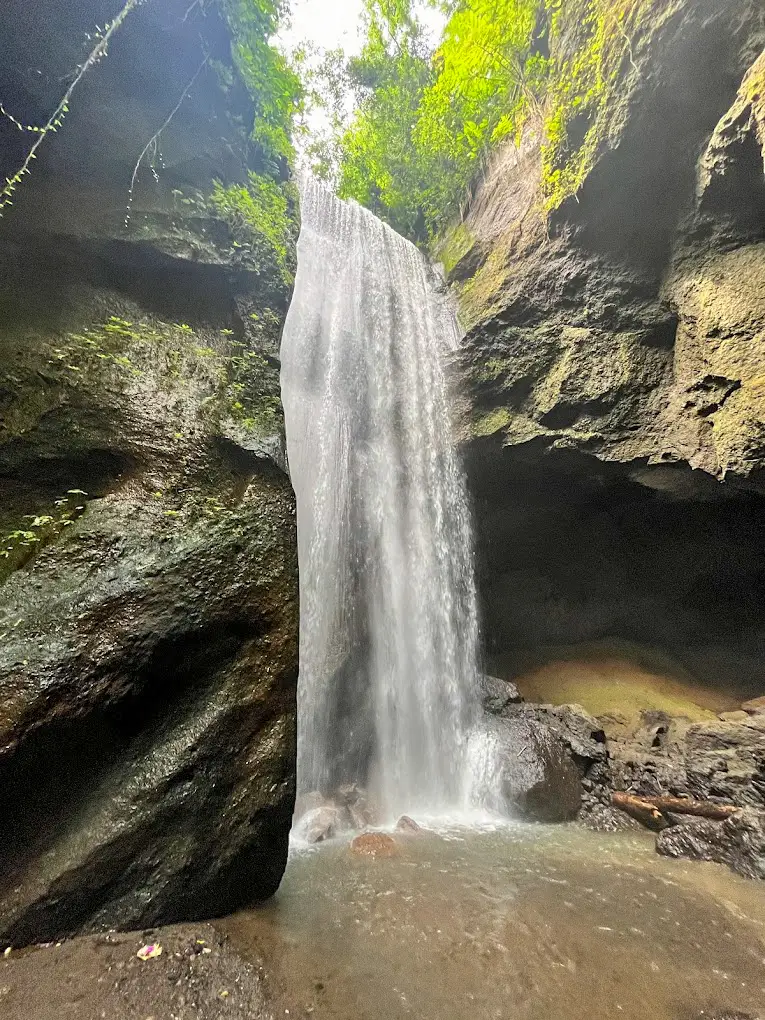 Goa Gajah Waterfall in between of two big rocks