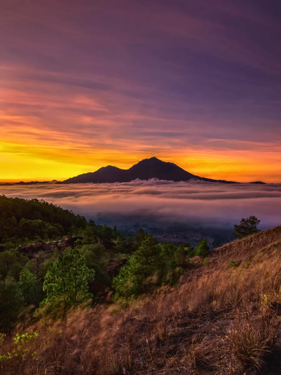 Sunrise at Mount Batur with yellow orange and purple skies