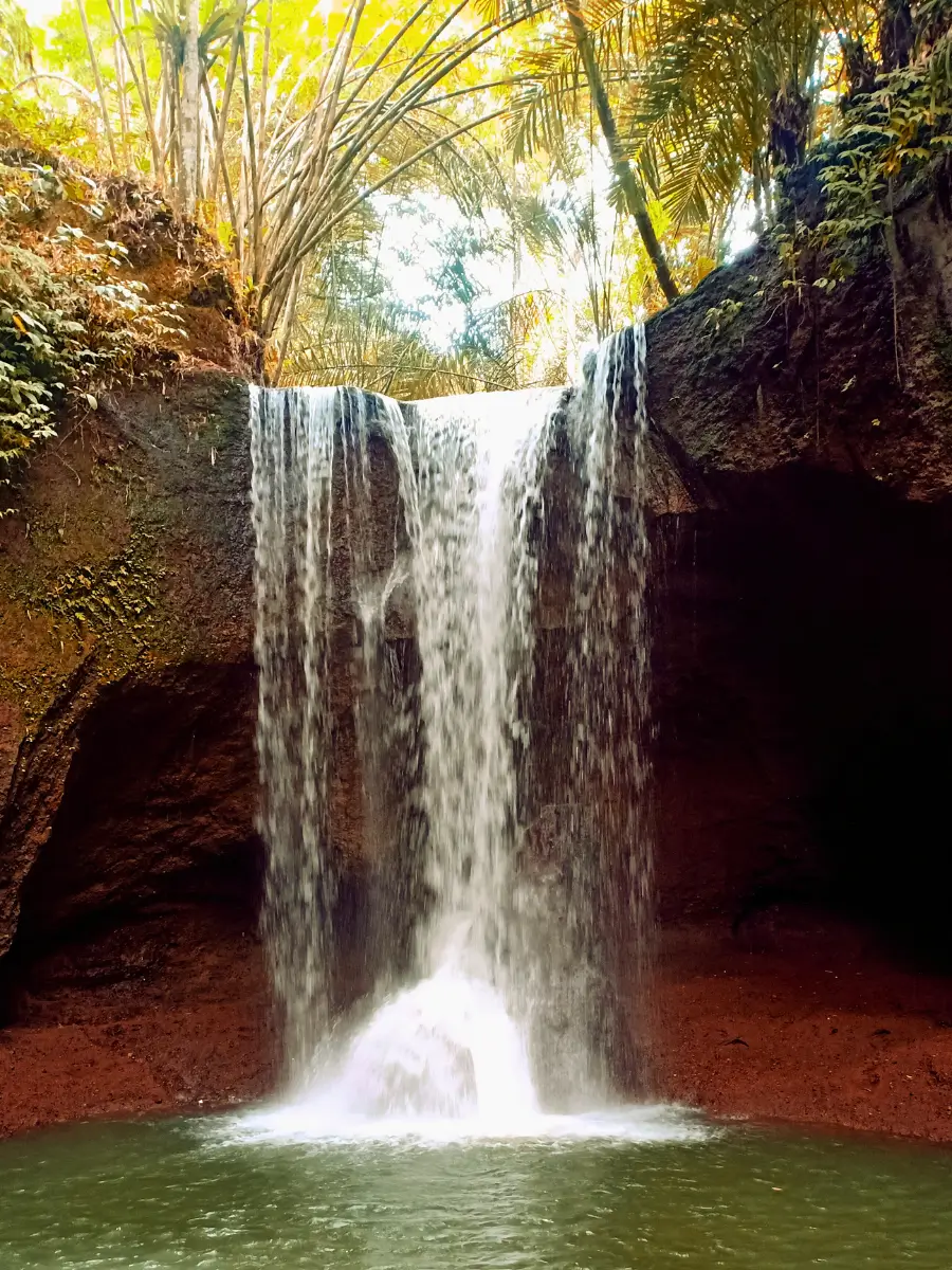 A stunning view of Suwat Waterfall surrounded by lush greenery.