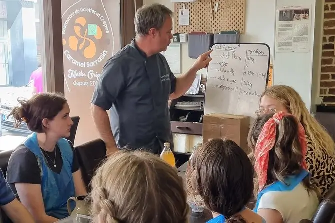 An instructor teaching important information about crepe making to his students