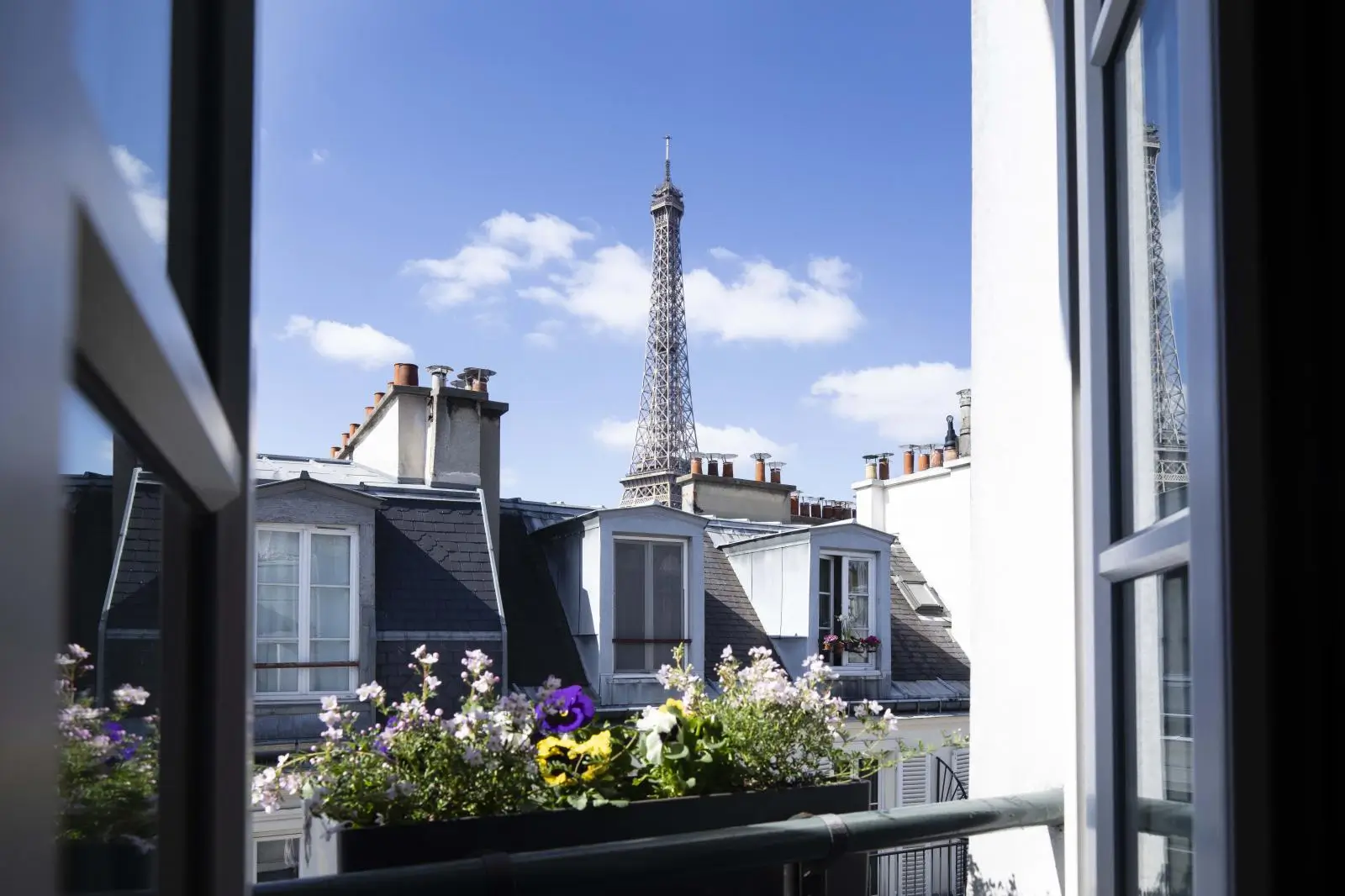 Quiet hotel in Paris offering a room with a stunning view of the Eiffel Tower, perfect for a peaceful and scenic stay.