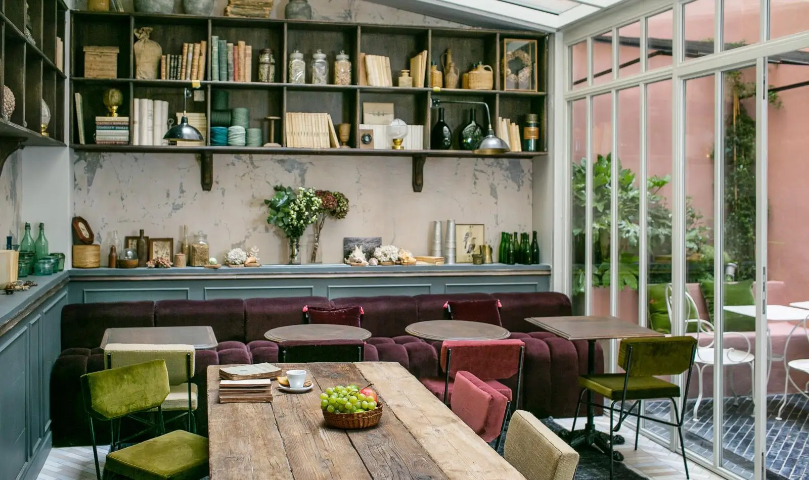 La Planque hotel's dining area in Paris exudes a warm and inviting atmosphere with its red-accented interior.