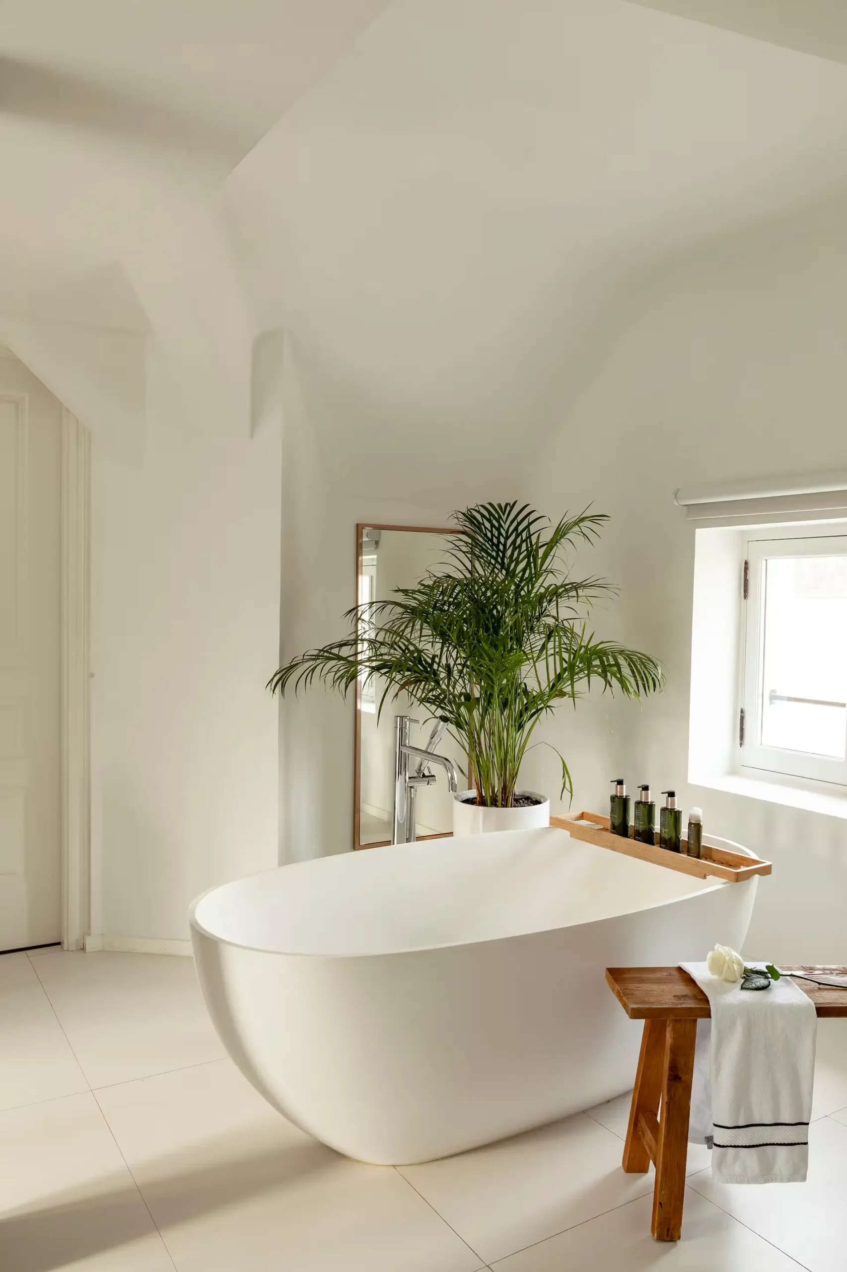 Luxurious bathroom with a sleek standalone bathtub at Maison Colbert Meliá Collection, Paris.