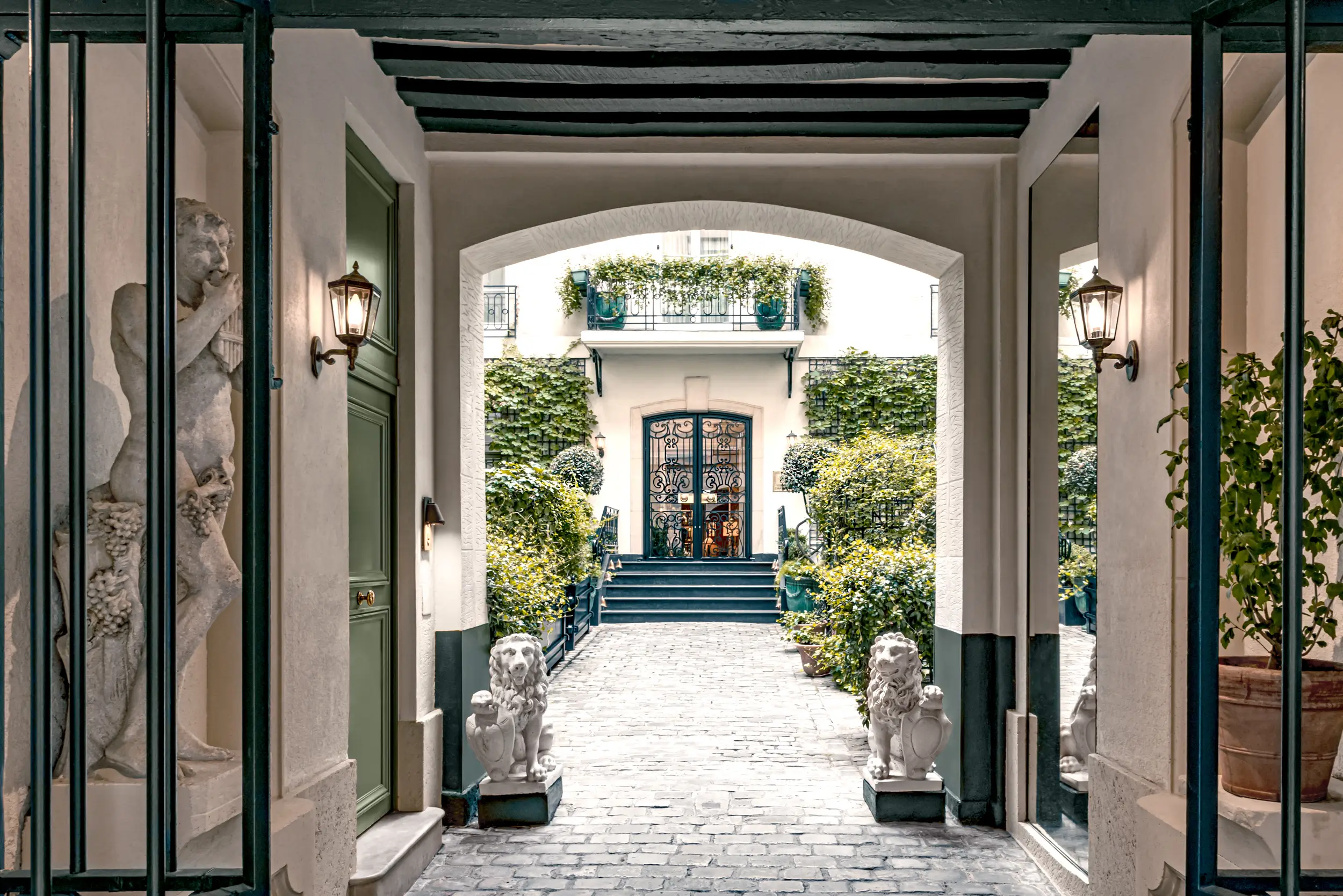 Charming entrance of Relais Christine, a quiet hostel in Paris featuring a peaceful courtyard.