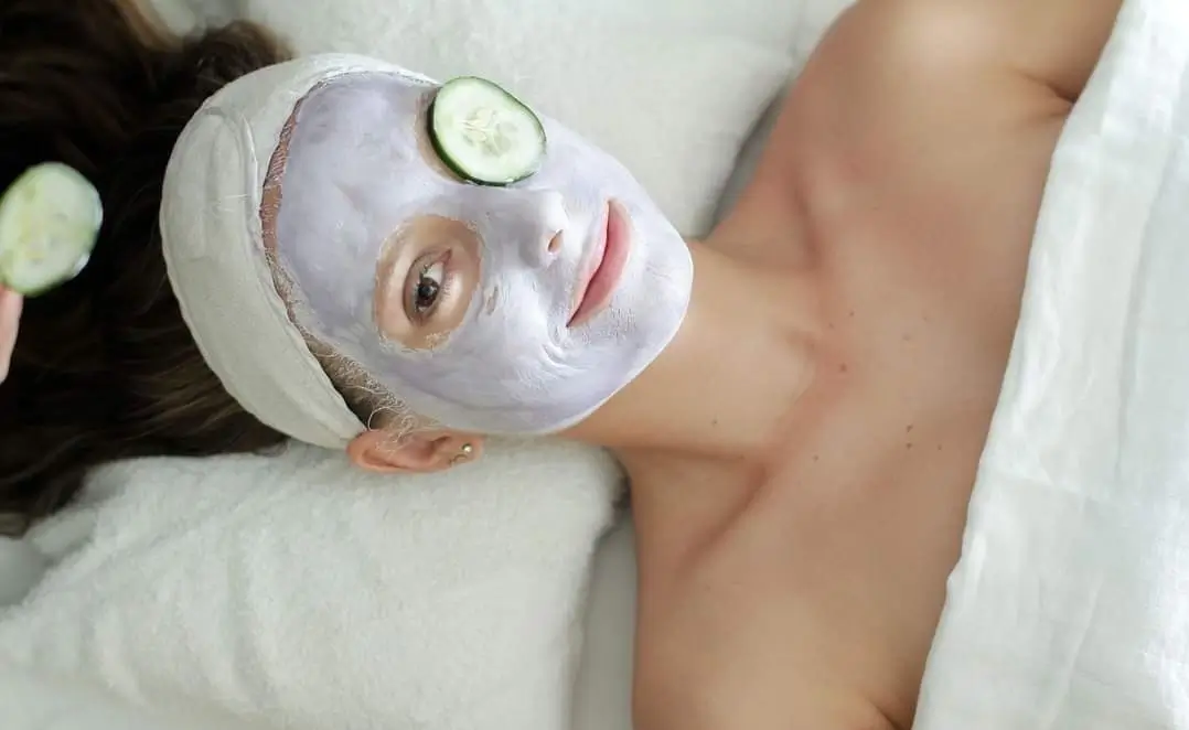 Close-up of a woman enjoying a spa treatment at Bella Isa Spa in Boracay, with a facial mask and a cucumber slice on her eye. Perfect for rejuvenation and relaxation, highlighting the best spa in Boracay.