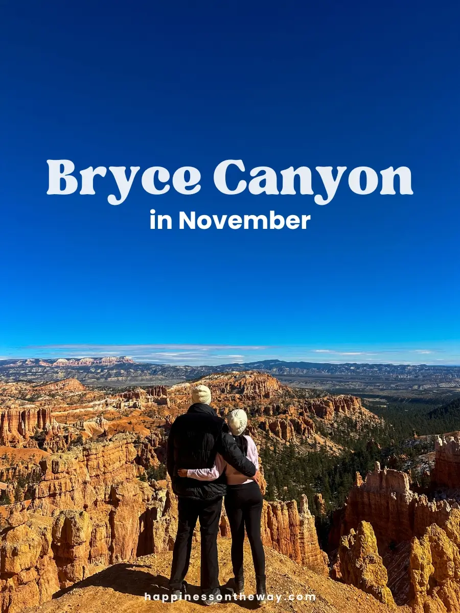 My partner and I standing at the edge of a stunning viewpoint in Bryce Canyon National Park, surrounded by orange hoodoos and a deep blue November sky.