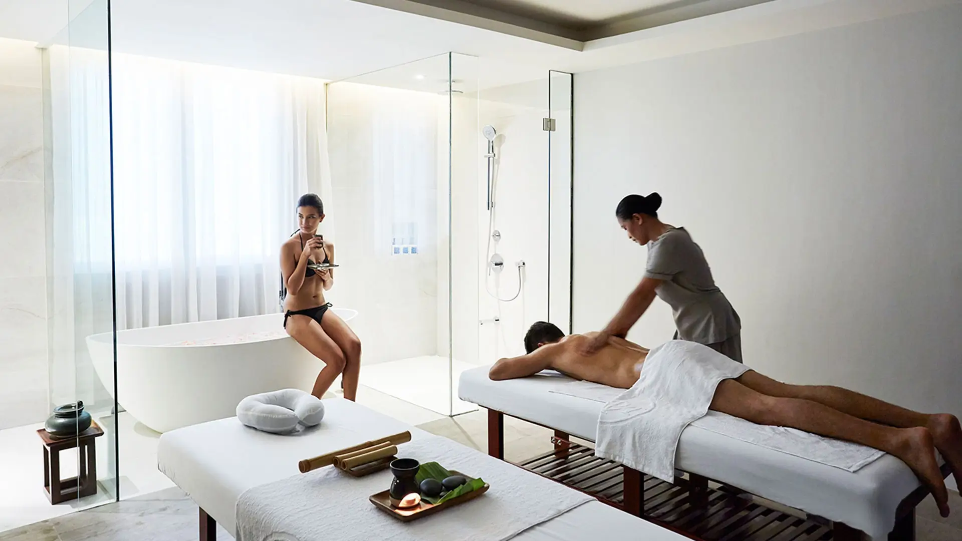 he spa at Lind Hotel Boracay, featuring minimalist interiors, two massage tables, and a view of tropical greenery.