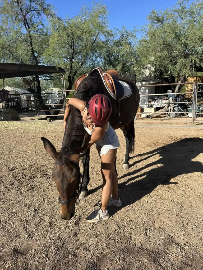 me hugging and taking care of a horse