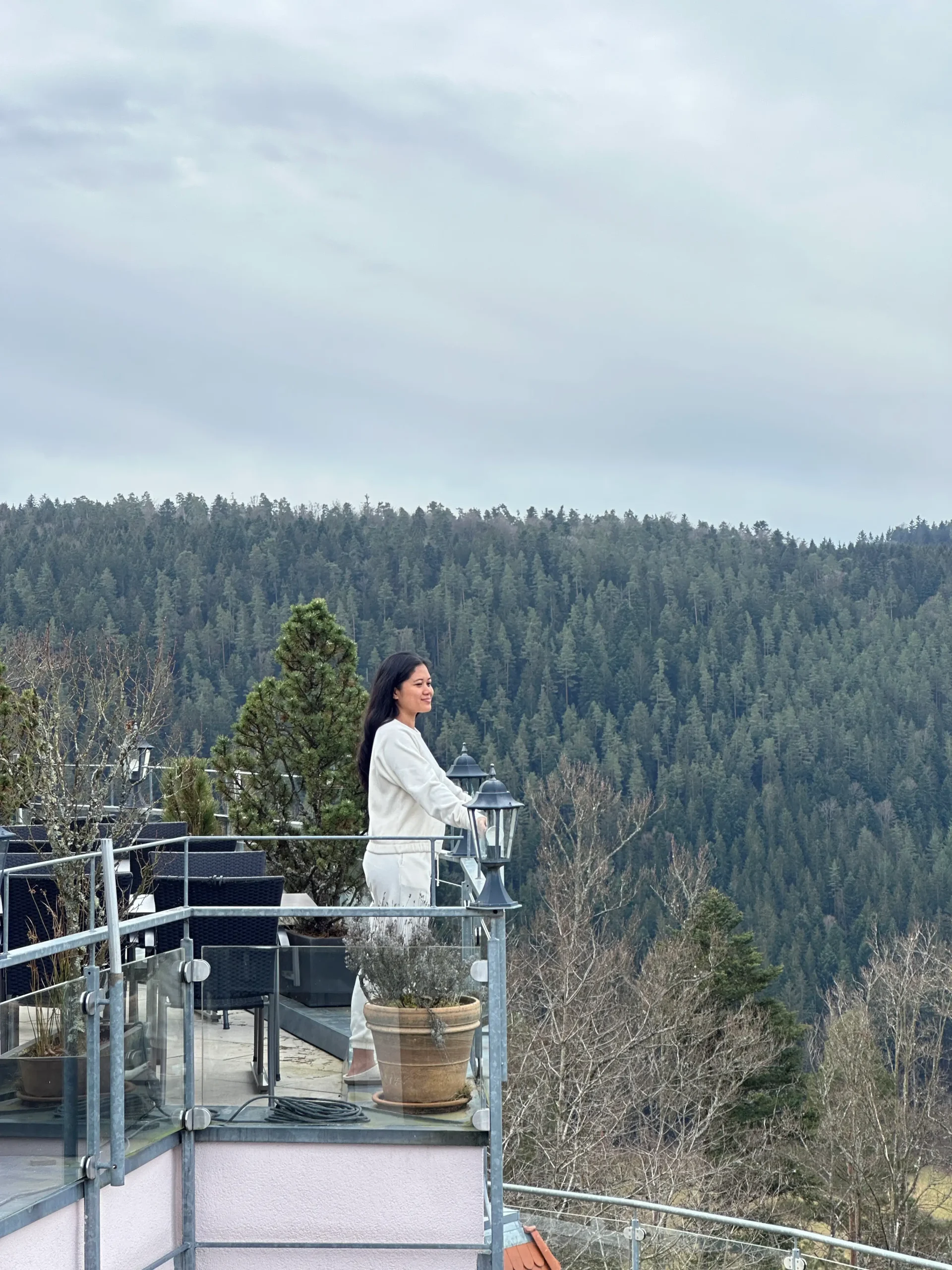 Me on a glass terrace overlooking dense forest