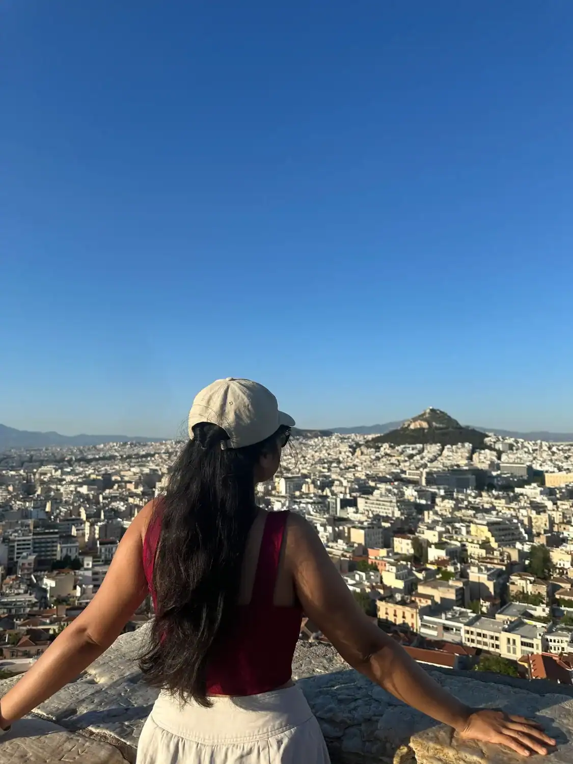 Filipino traveler overlooking the cityscape of Athens, Greece.