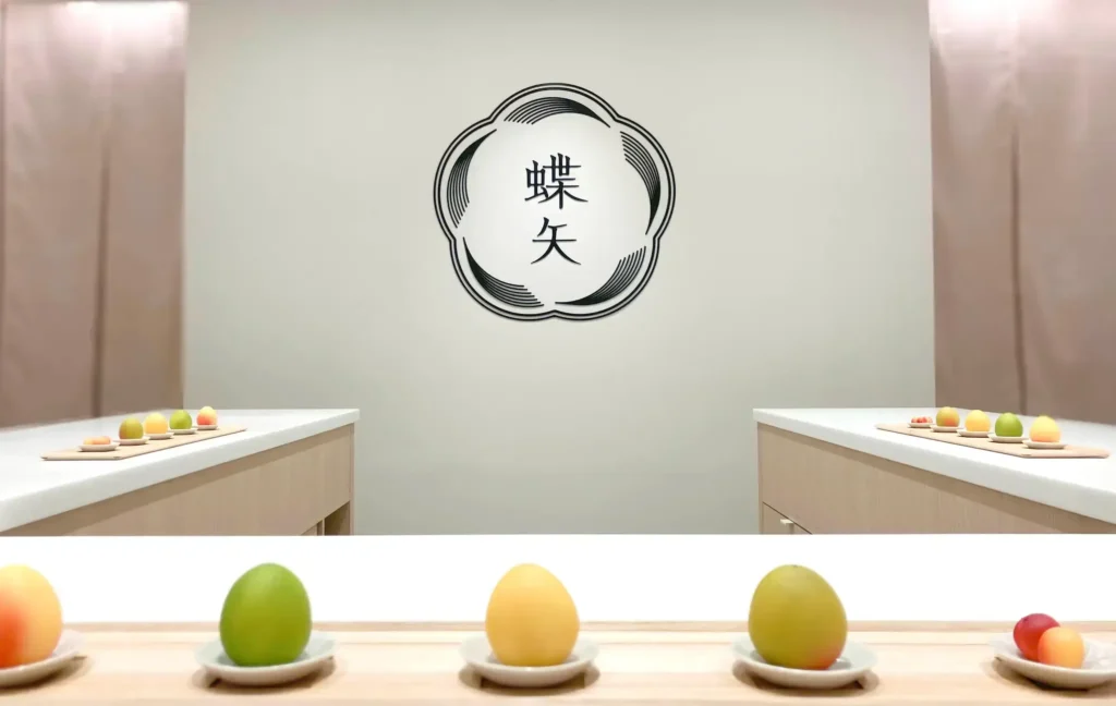 Colorful ume plums displayed on small plates inside a clean workshop space, ready for making umeshu and ume syrup.