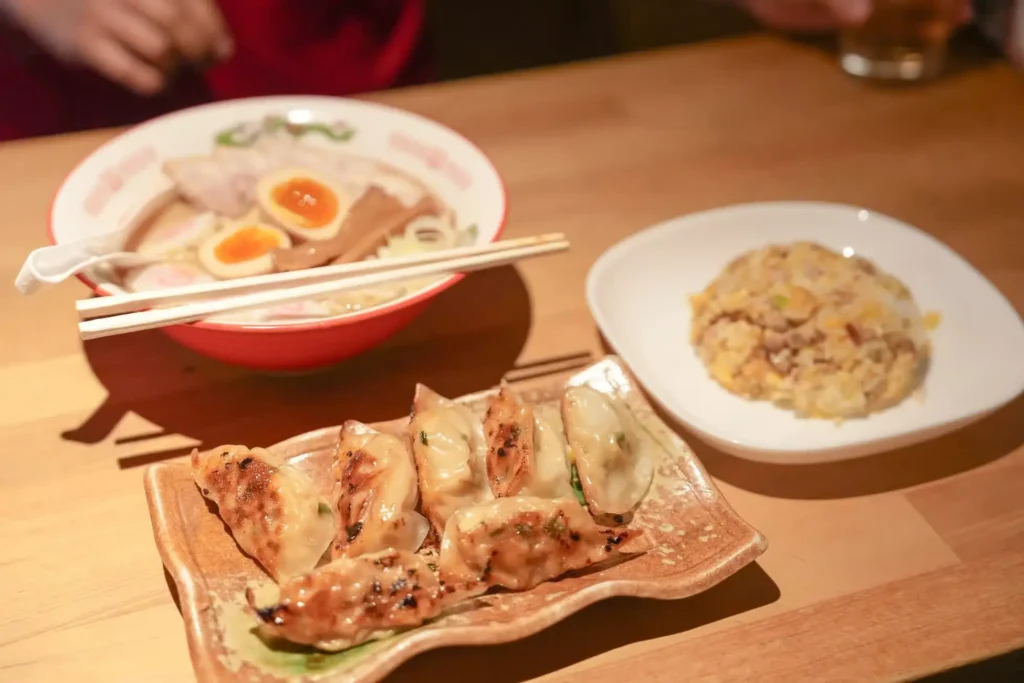 Pan-fried gyoza, a bowl of ramen with soft-boiled eggs.