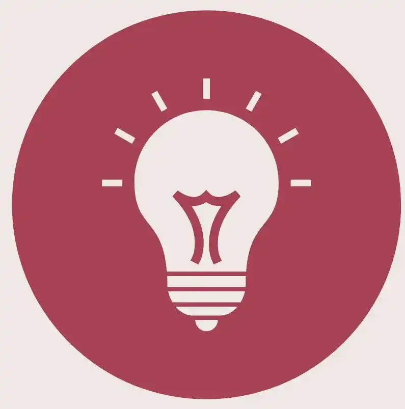 A pale pink lightbulb against a maroon circle for an article about the best places to stay in Talkeetna.