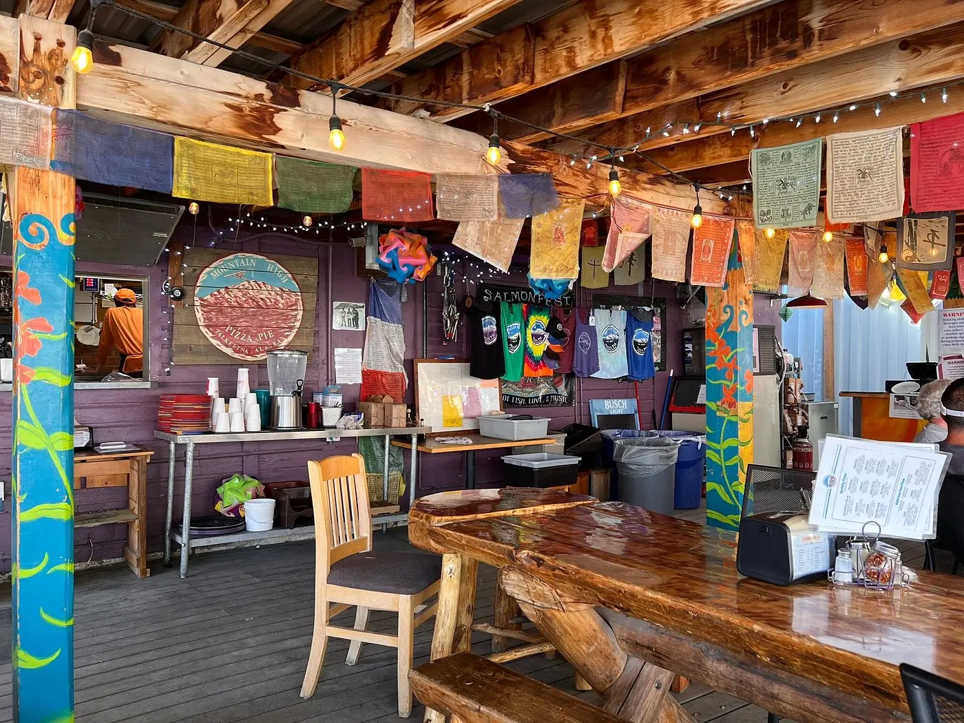 Colorful ribbons, twinkling lights, and wooden tables adorn Mountain High Pizza Pie, one of the  best places to eat in Talkeetna, Alaska.