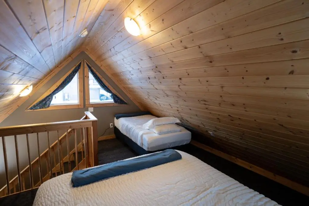 Two single beds in The Talkeetna Landing, a cabin for travelers who want cozy places to stay in Talkeetna.