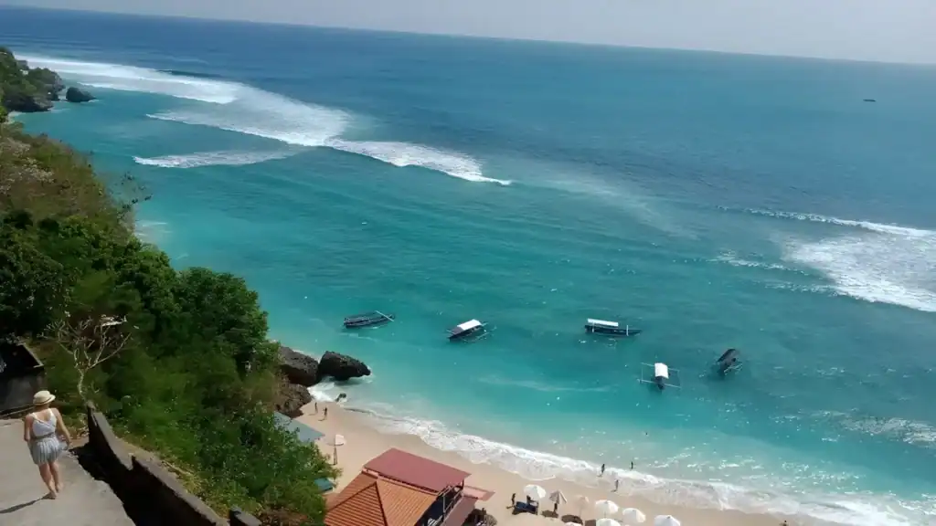 Padang Padang Beach in Uluwatu viewed from above, with clear water and surrounding cliffs.