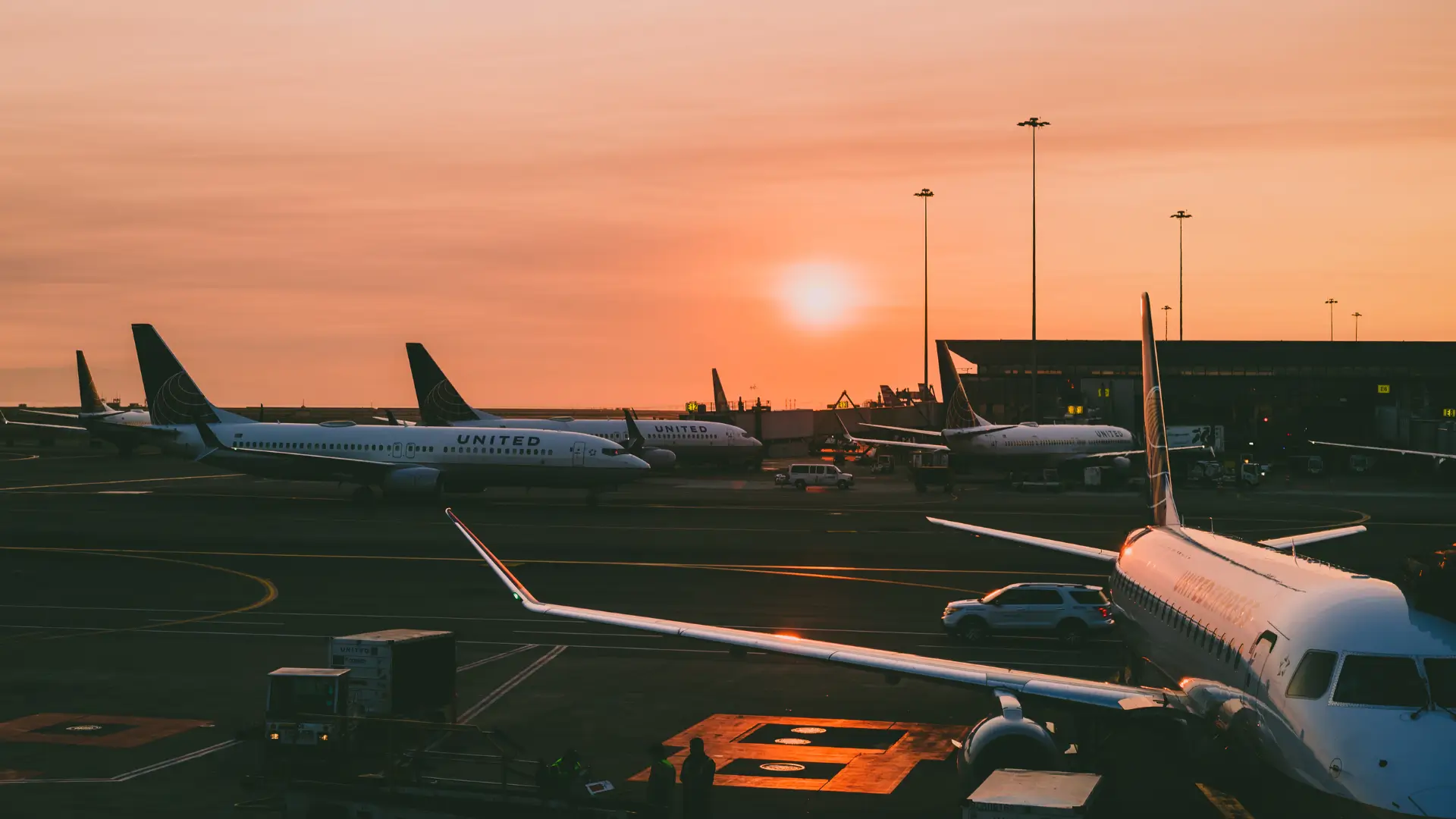 Do I need travel insurance for Japan? Are airplanes ready for departure at Tokyo airport during sunset?