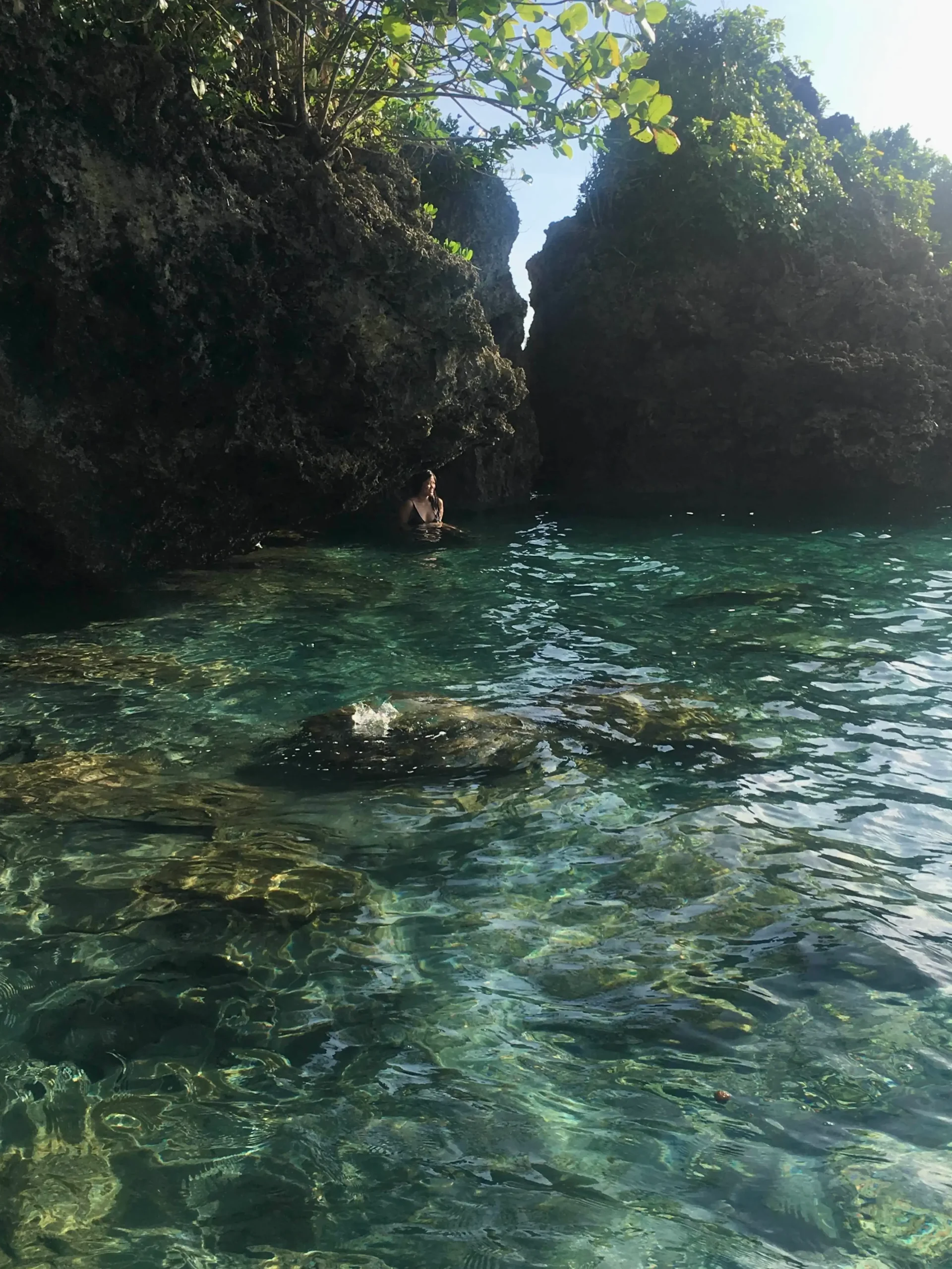 Two large rocks stand against the turquoise waters  of Magpupungko Rock Pools, Siargao, one of the top tourist destinations in Mindanao.